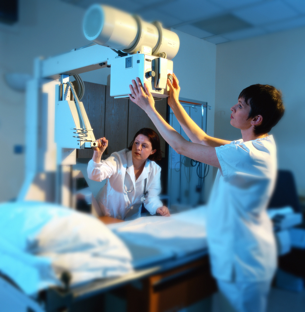 view of x-ray technicians operating an x-ray machine